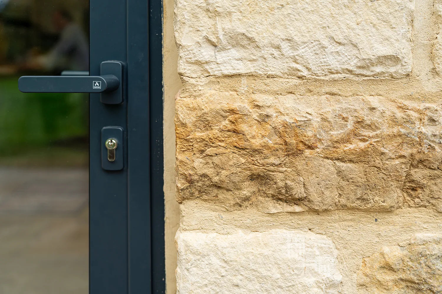 Close-up of a door handle on a stone wall