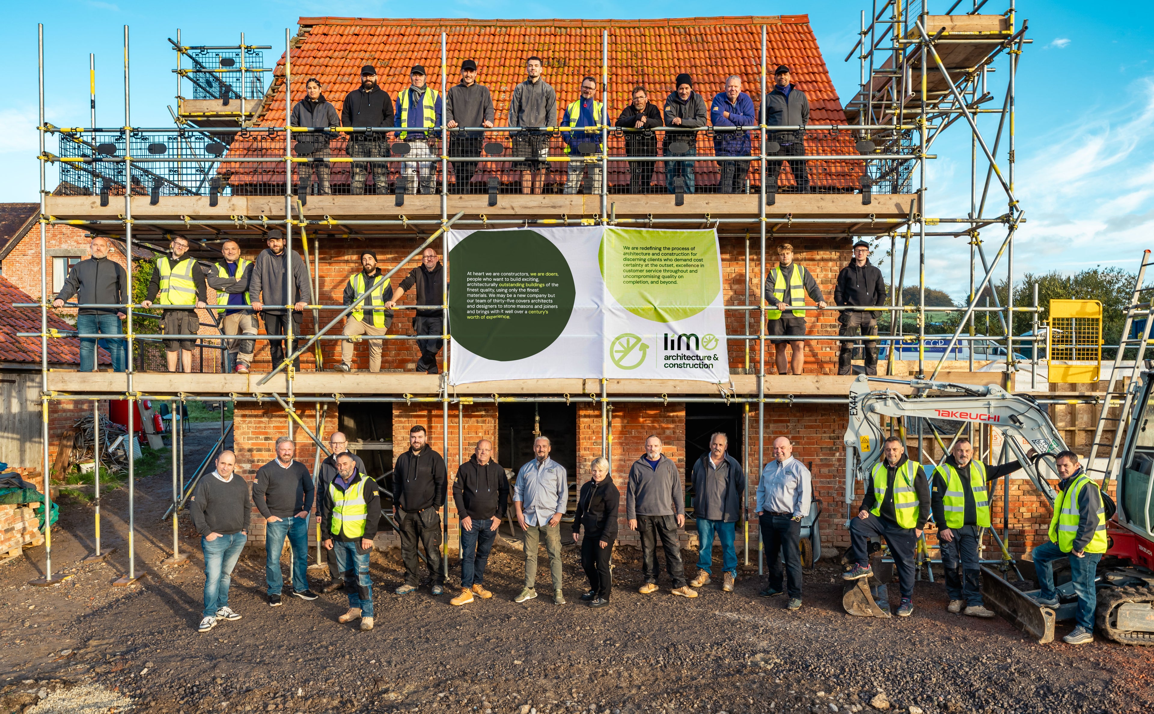 Group of people standing on scaffolding in front of a wooden building with Lime branding.